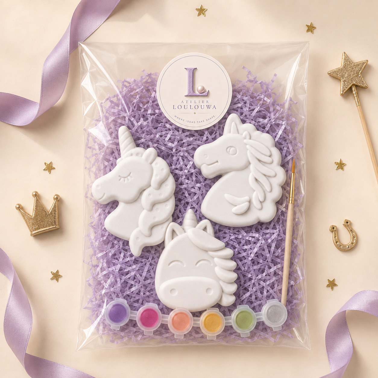 Unicorn Trio kit as it arrives: gypsum pieces, paints and a brush