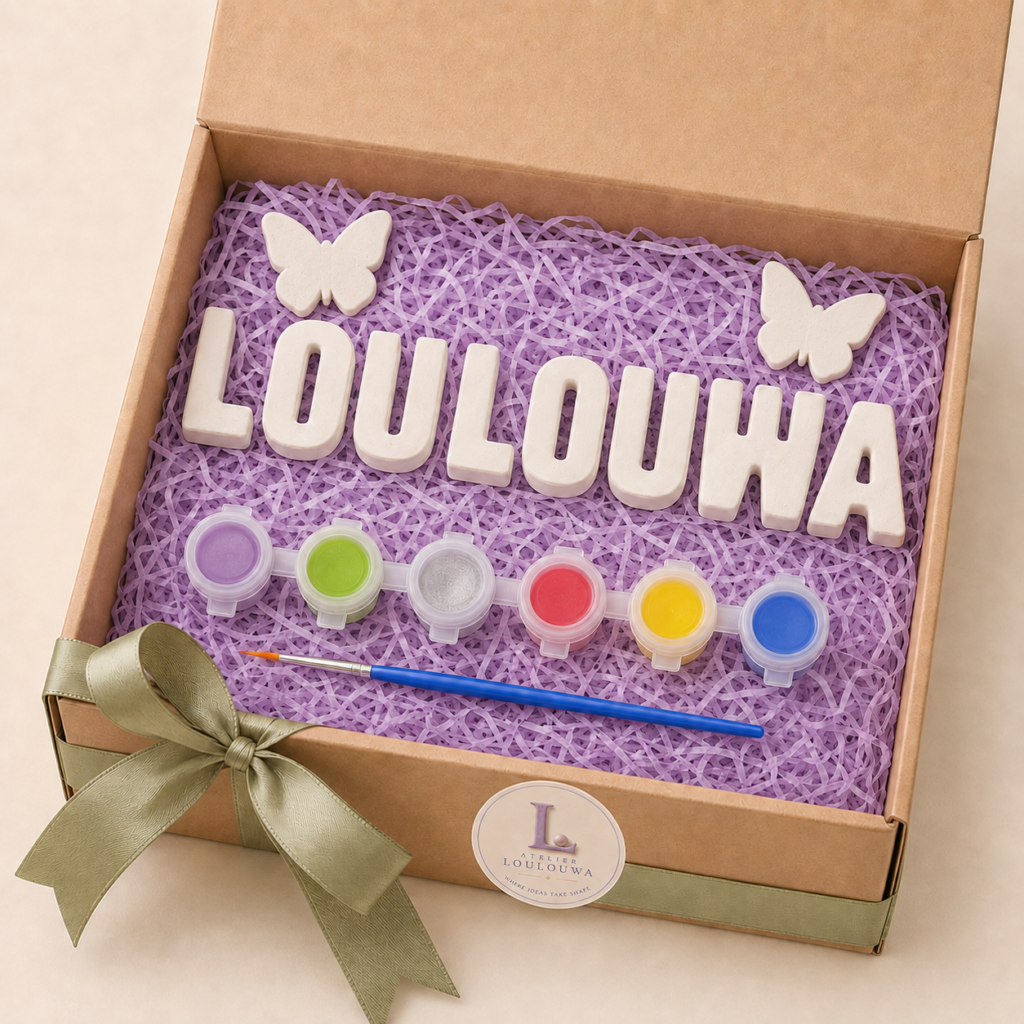 Gypsum letters spelling LOULOUWA with two gypsum butterflies, in a gift box with six pots of paint and a brush